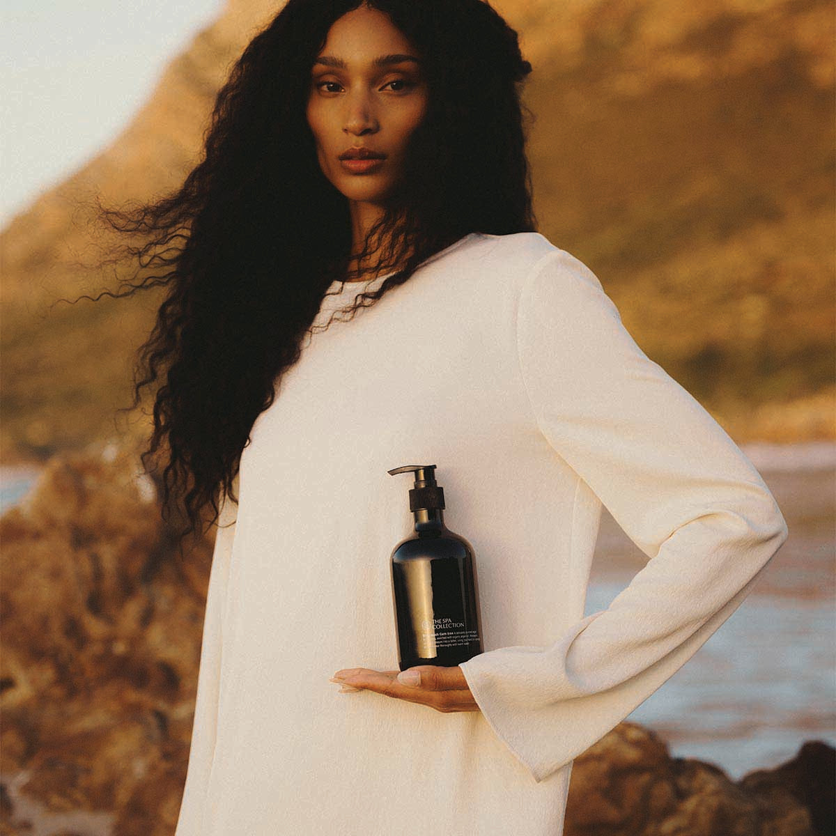 Gum Tree shampoo bottle held in hand by model